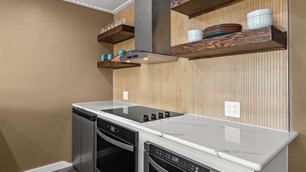 Modern appliances with range & oven and under counter refridgerator.