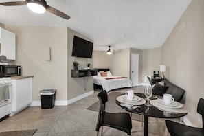 Open Living And Dining Area With A 42" Smart TV And Modern Decor