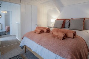 bedroom with king size bed looking into the hallway