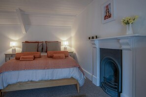 bedroom with king size bed and fireplace