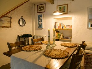 Dining table for four and book shelf with local books