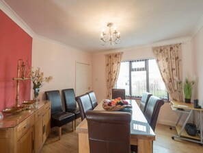 Driftwood dining room with table to seat 8, sideboard and desk.