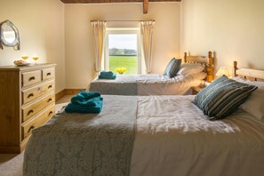2 single beds with bedside cabinet and lamp and chest of drawers