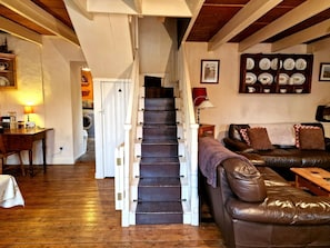 Lounge area with stairs leading to first floor