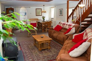 Wood burner , coffee table, two large sofas and a rocking chair