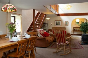Open plan dining and living area and stair leading to first floor