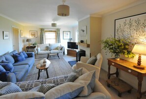 Comfortable sofas and armchairs. Woodburner and TV