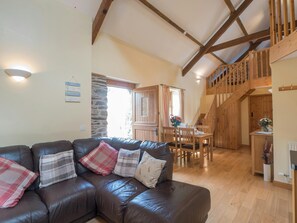 Living/dining area in Eirlys showing sofa, table and chairs, stairs leading to the first floor