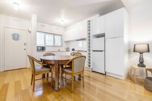 A dining table invites you to sit down for a meal at home or set up a laptop if you’re on a working holiday.

