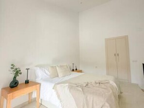Bright master bedroom with double bed, two bedside tables and storage area. (1)