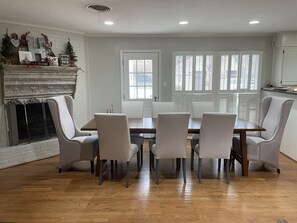 Dining table seats 8 with a backyard view.
