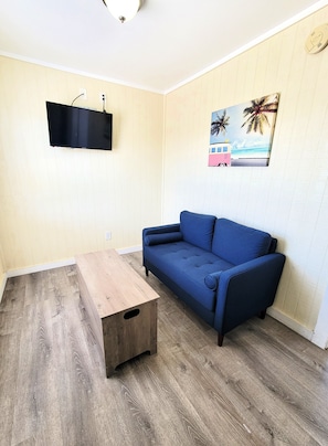 The living area has a love seat and coffee table with cable TV and wifi