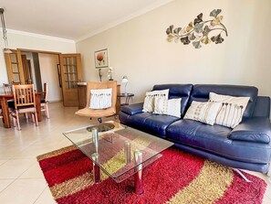 Furniture, Interior Design, Couch, Flooring, Floor, Room, Living Room, Television, Ceiling, Picture Frame