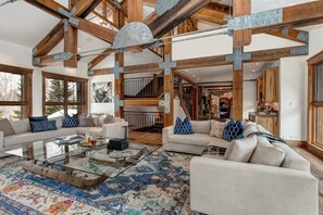 Two sectional couches surround a glass coffee table in the main living space.