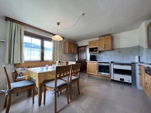 Furniture, Cabinetry, Table, Window, Building, Countertop, Curtain, Wood, Chair, Kitchen