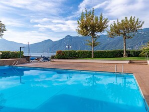 Sky, Building, Property, Table, Furniture, Cloud, Mountain, Interior Design, Outdoor Furniture, Wood