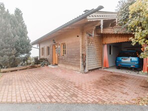 Plant, Sky, Building, Garage Door, Wheel, Vehicle, Car, Asphalt, Wood
