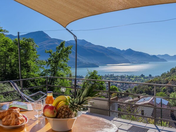 Water, Sky, Property, Mountain, Azure, Tableware, Shade, Outdoor Furniture, Lake, Building