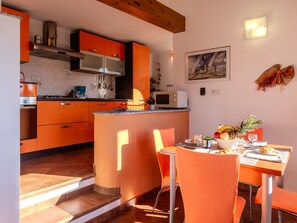 Furniture, Property, Cabinetry, Picture Frame, Table, Orange, Countertop, Wood, Interior Design, Kitchen