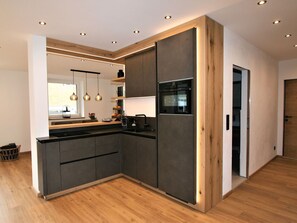 Cabinetry, Property, Furniture, Building, Wood, Countertop, Interior Design, Houseplant, Hall, Flooring