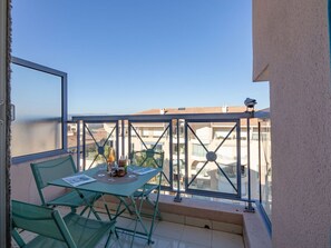 Sky, Furniture, Property, Table, Building, Chair, Shade, Interior Design, Outdoor Furniture, Window