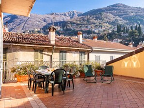 Sky, Furniture, Plant, Property, Table, Mountain, Flowerpot, Chair, Azure, Building