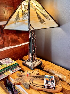 Unique books  & a custom moose cribbage board are some of many cabin decor items