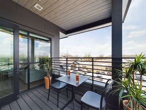 Unit 1: Private balcony with outdoor seating and refreshing Downtown views.