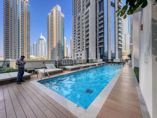 Rooftop Oasis: Dive into city views from your refreshing poolside retreat!
