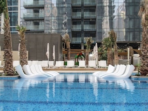 Pool Oasis: Lounge in style on sleek loungers with palm-fringed views and shimmering waters!