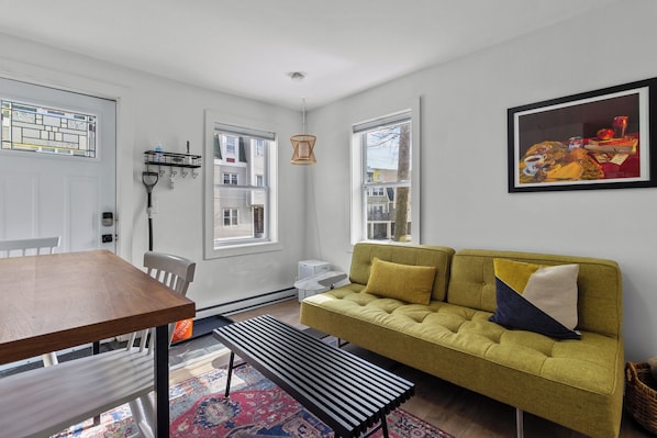 Chic and inviting living area with a stylish sofa, modern decor, and plenty of natural light.