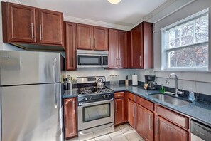 Fully equipped kitchen with wooden cabinets