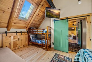 The upstairs bedroom also includes bunk beds and a sleeper futon for additional space that is great for kids.