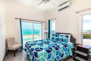 A plush queen bed in the oceanview bedroom w/ a private terrace