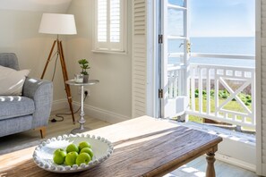 French windows in the living room overlook the sea