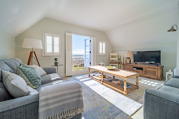 The light-filled living room overlooks the sea