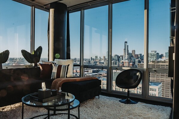 Indulge in modern luxury: Lounge in our spacious living room with skyline views.