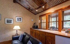 Step into the living area of Bear's Den, a cozy retreat that invites relaxation. Unwind by the fireplace after a day of adventure, with an open layout perfect for enjoying quality time togethe