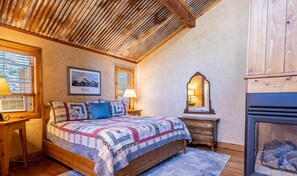 Retreat to the spacious king bedroom at Bear's Den, your perfect haven after a day of adventure. Relax by the cozy fireplace and enjoy a restful night’s sleep, surrounded by the peaceful ambia