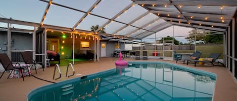 String lights over the pool add a nice evening ambiance. The pool and backyard patio offer comfort and tranquility. 🏊♂️☀️ #PoolsideParadise #BackyardBliss #BeachinEscape