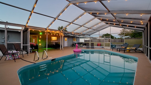 String lights over the pool add a nice evening ambiance. The pool and backyard patio offer comfort and tranquility. 🏊‍♂️☀️ #PoolsideParadise #BackyardBliss #BeachinEscape