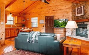 The seamless flow between the kitchen, dining, and living spaces creates a welcoming environment, perfect for cozying up by the fireplace, watching your favorite shows, or enjoying a meal toge