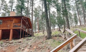 Ascend up the stairs and find out why this cabin is claimed a guest favorite. Tucked away in the serene woods, this secluded retreat offers a peaceful escape that keeps guests coming back.