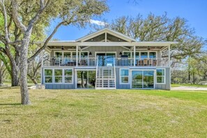 Back of home facing the lake. Endless outdoor space. Great for football, cornhole, and family games