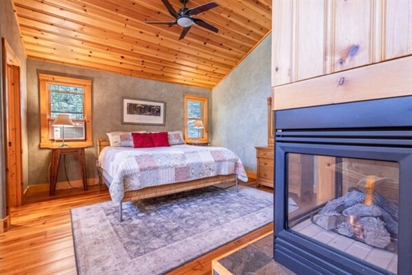 Cozy up in our inviting bed, where the flickering flames of the fireplace set the perfect ambiance for relaxation and comfort.