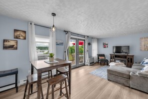 Open concept dining and living with access to large deck overlooking the harbor.