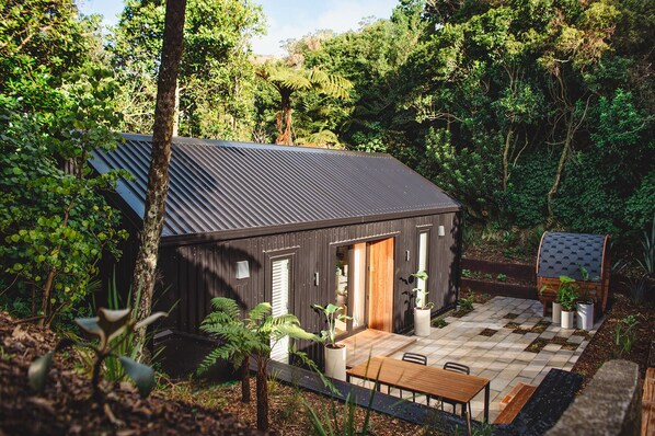 A modern architectural take on the cabin in the woods, with sauna and patio.