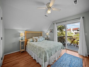 Guest Bedroom 1 features a lot of natural light and coastal vibes