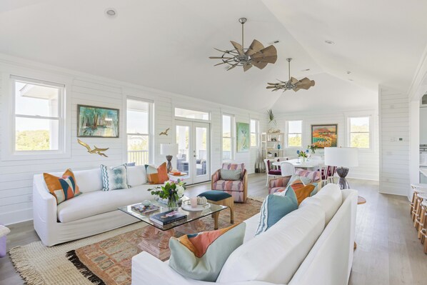 Expansive living room with a lot of seating and open to both dining and kitchen.