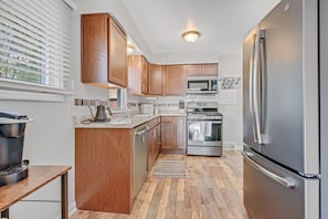 Full equipped kitchen with gas stove, dishwasher, garbage disposal, & coffee bar
